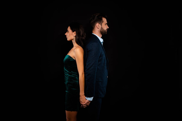 Close up side profile photo amazing pair she her chic he him his macho stand back to back tender wedding dance motion wear blue costume jacket green glossy velvet dress isolated black background - Foto, Imagem