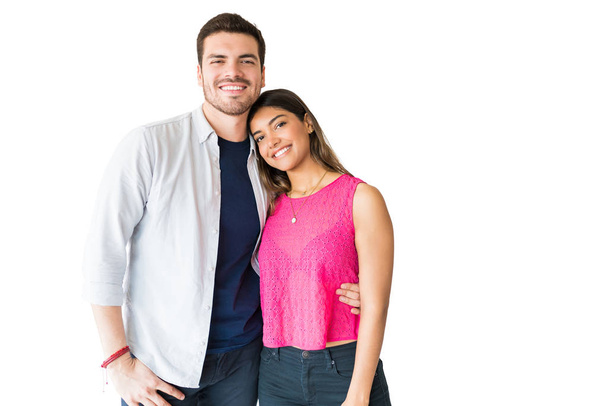 Portrait of smiling young fashionable lovers standing together in studio - Foto, immagini