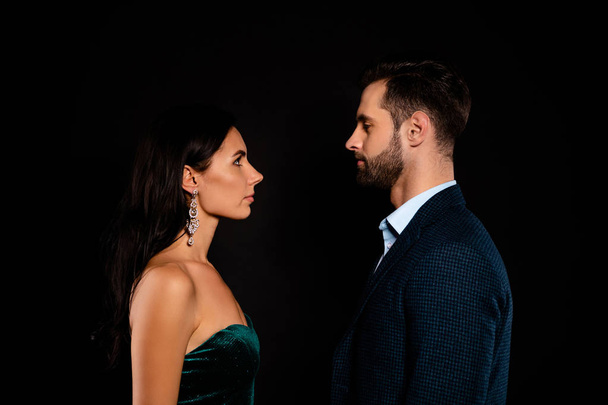 Close up side profile photo pair she her classy chic he him his macho enemies stand opposite look eyes not smiling tenderness wear plaid blue costume jacket green dress isolated black background - Φωτογραφία, εικόνα