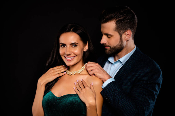 Close up side profile photo two beautiful people she her classy chic he him his macho giving receive take on neck bijouterie jewel wear plaid blue costume jacket green dress isolated black background - Fotoğraf, Görsel