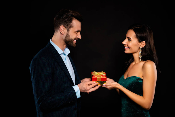 Profile side view portrait of nice lovable attractive lovely luxurious fascinating cheerful dreamy two person giving receiving expensive package rich wealthy guy isolated over black background - Foto, Bild