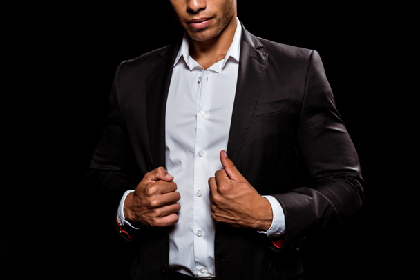 cropped view of bi-racial man touching formal wear isolated on black  - Fotografie, Obrázek