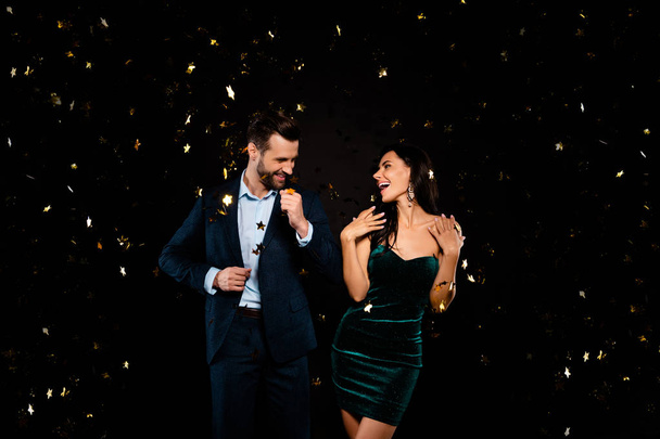 Portrait of his he her she nice-looking classy well-dressed adorable attractive glamorous cheerful ecstatic excited two person flying decorative element having fun feast isolated on black background - Foto, afbeelding