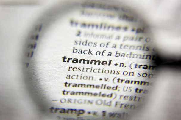 The word or phrase Trammel in a dictionary. - Photo, Image