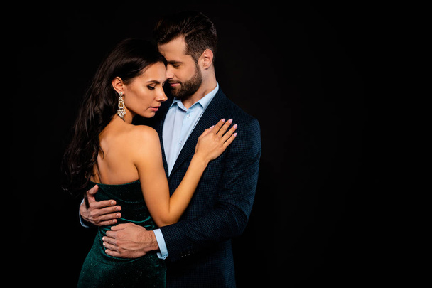 Close up side profile photo beautiful she her wife bride he him his husband fiance mrs mr married spouse protect hands slim waist hold close wear costume jacket green dress isolated black background - Foto, Imagem