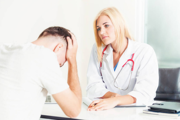 Woman Doctor and Male Patient in Hospital Office - Photo, Image