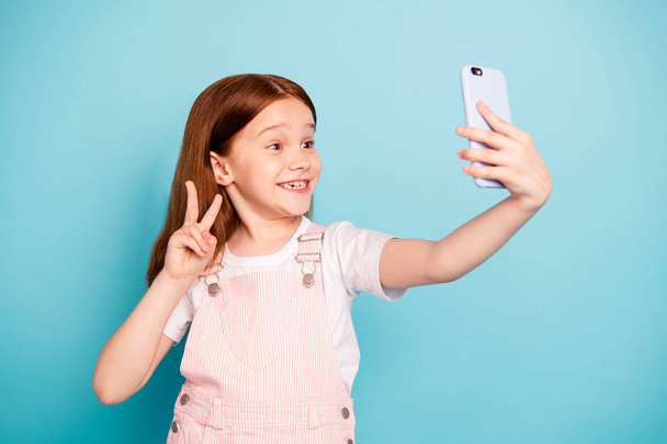 Portrait of nice cute kid make v-signs photo wear trendy stylish overalls isolated blue background - Φωτογραφία, εικόνα