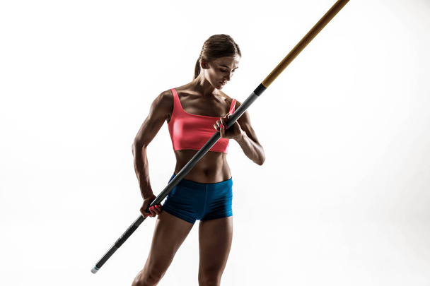 Female pole vaulter training on white studio background - Фото, изображение