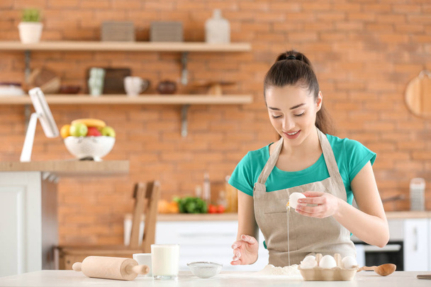 Piękna kobieta przygotowuje piekarnię w kuchni w domu - Zdjęcie, obraz