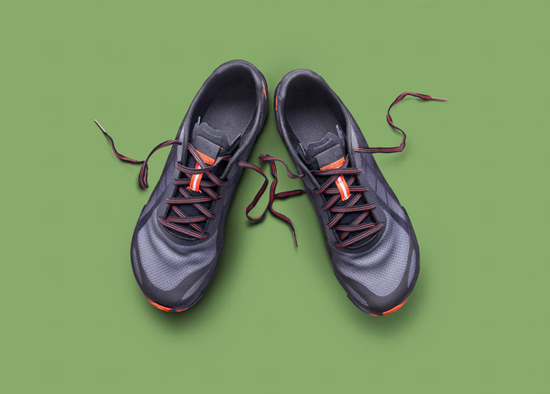 Top view of gray and orange trainers isolated on a green backgro - Photo, Image