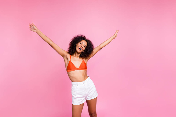 Close up photo attractive beautiful she her dark skin bright lady stylish trendy funky see friends amazed crazy overjoyed girlish fit wear swimming orange suit white shorts isolated pink background - Foto, Bild