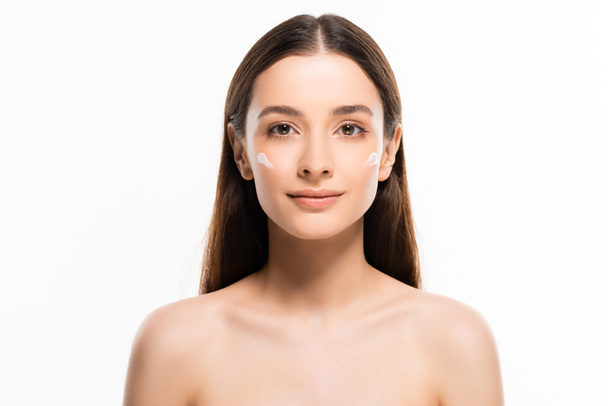 beautiful young naked woman with perfect skin and cosmetic cream on face isolated on white - 写真・画像