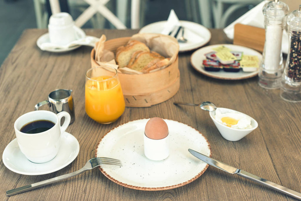 Continental breakfast of egg juice coffee and yogurt on the table. Food concept - 写真・画像