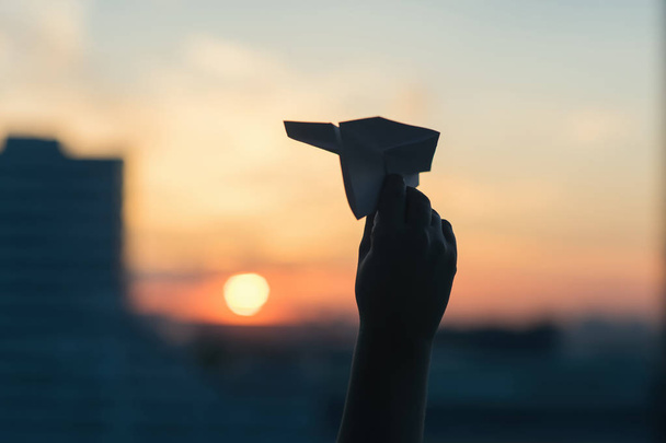 Paper airplane against the sunset sky - 写真・画像