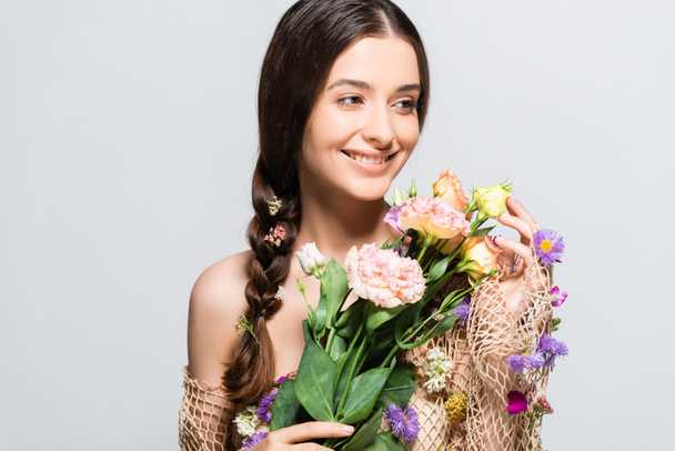 souriant belle femme avec tresse en maille avec printemps fleurs sauvages isolées sur gris
 - Photo, image