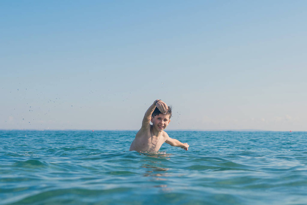 13 ans garçon nageant et se relaxant dans les vagues de la mer. Concept de vacances d'été en famille
 - Photo, image