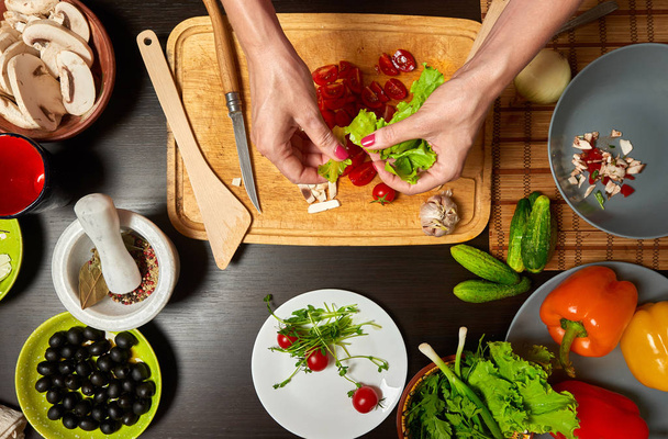Close-up overhead shot de mãos de mulher preparando uma salada saudável
 - Foto, Imagem