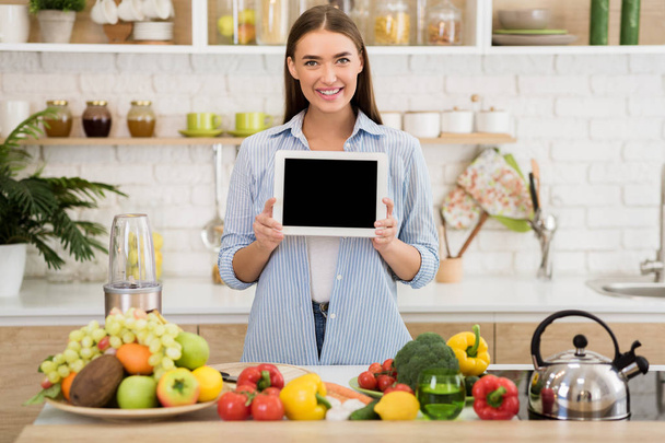 Culinary concept. Woman holding tablet with blank screen - Photo, Image