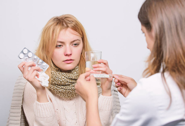 Girl in scarf examined by doctor. Cold and flu remedies. Doctor communicate with patient recommend treatment. Doctor ask patient about symptoms. Flu and cold treatment. Woman consult with doctor - Valokuva, kuva