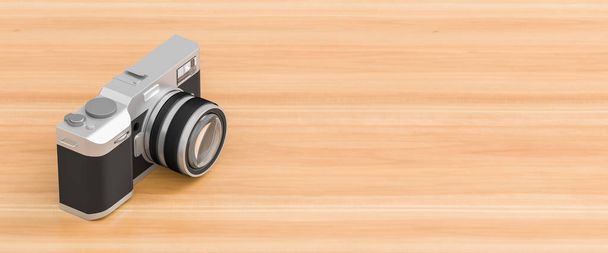 Retro looking digital camera isolated on wooden background - Photo, Image
