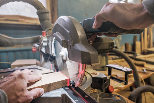Hombre caucásico carpintero trabajador que conduce sierra circular para cortar tablas
 - Foto, Imagen