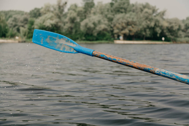 Paddle with plastic paddle above  water - Fotografie, Obrázek