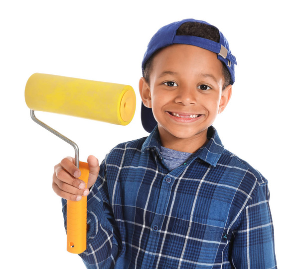 Cute African-American boy with paint roller on white background - Photo, Image