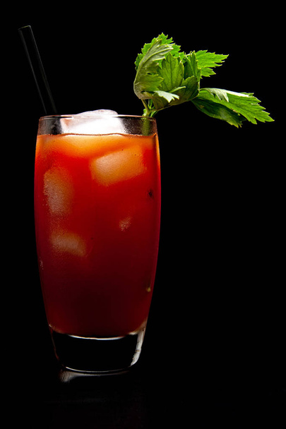 Bloody Mary with ice cubes with celery isolated on black - Fotografie, Obrázek