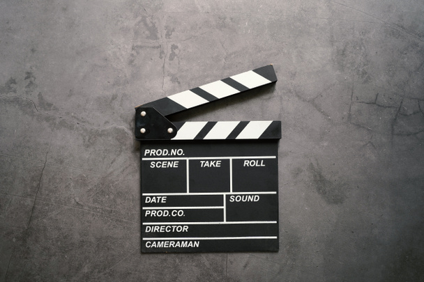 Empty clapperboard in flat lay style on dark stone background, entertainment and cinema industry concept  - Photo, Image