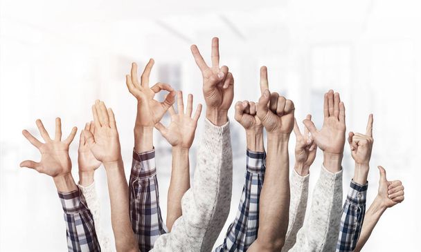 Row of man hands showing various gestures. Ok, finger pointing, victory, spread fingers, clenched fist and thumb up signs. Human hands gesturing on light blurred background. Many arms raised together. - Photo, Image