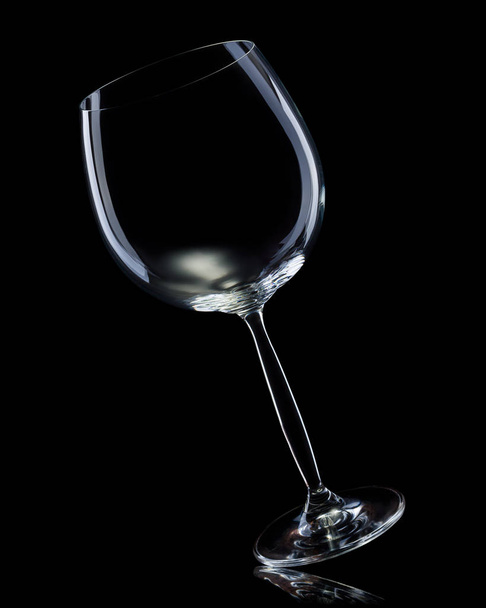 Empty glass for red wine isolated on black background. - Φωτογραφία, εικόνα
