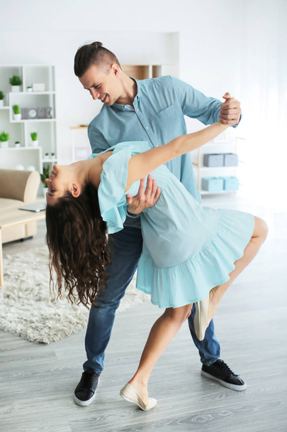 Adorable loving couple dancing at home - 写真・画像