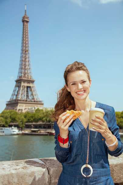 happy solo traveller woman with cup of coffee and croissant - Fotó, kép