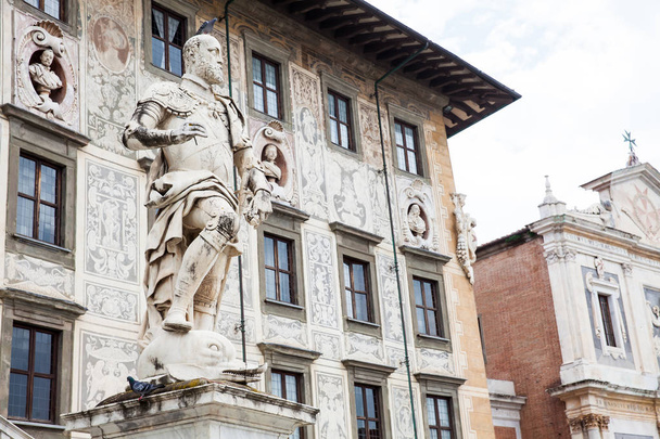 The statue of Cosimo I de Medici in front of Palazzo della Carovana built in 1564 located at the palace in Knights Square in Pisa - Zdjęcie, obraz