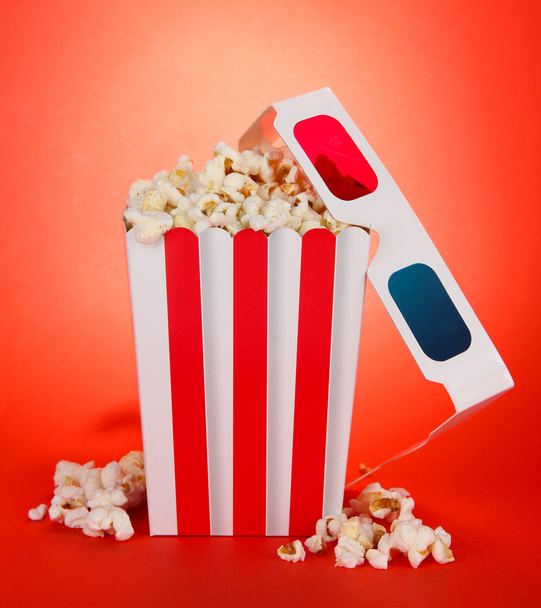 Popcorn and 3D glasses on red background - Fotografie, Obrázek