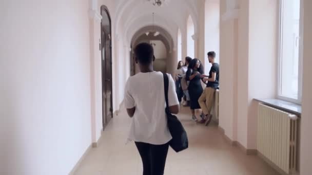 View from back of student going alone through corridor - Filmmaterial, Video