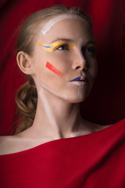 Girl with color make-up on a red background. - Foto, Imagem