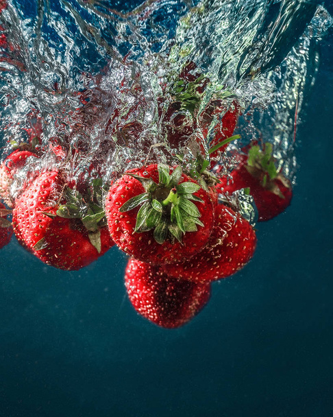 fresh summer strawberries. Strawberries in water. spray, berries, red and blue. still-life. background. abstraction. food. photo of food. Strawberry berries fall into the water. lovely fresh taste of summer. - Fotoğraf, Görsel