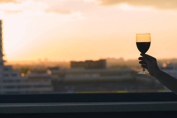 Silhouette of woman with glass of red wine  - Foto, immagini