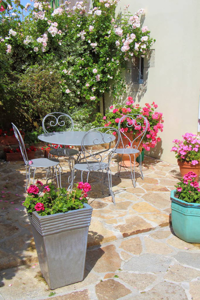 Terrazza fiorita con mobili da giardino
 - Foto, immagini