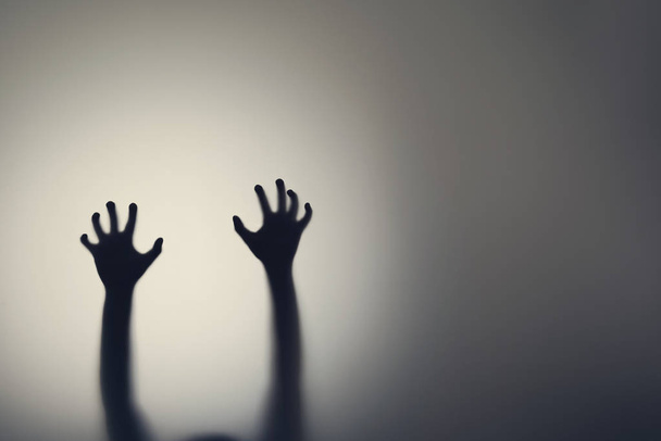 Dark silhouette of woman hands behind glass door. Concept of depression, fear, panic attacks - Φωτογραφία, εικόνα