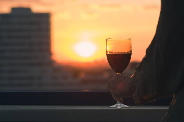 Silhouette of woman with glass of red wine  - Fotó, kép