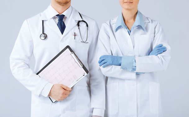 Nurse and male doctor holding cardiogram - Photo, image