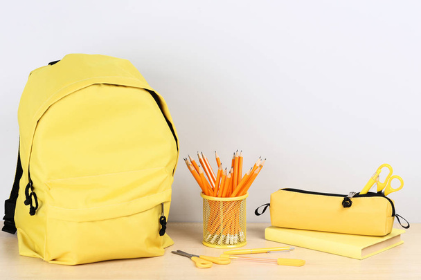 Backpack with school supplies on grey background - Φωτογραφία, εικόνα
