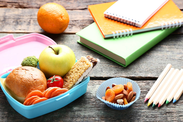 School lunch box with sandwich and pencils on wooden table - Φωτογραφία, εικόνα
