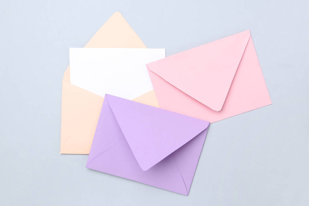Colorful paper envelopes on grey background - Foto, Imagen