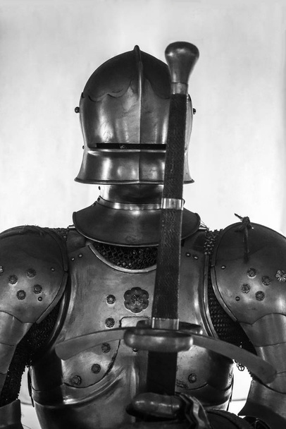Knight with sword. Powerful heavy fighter with sword and helmet - Foto, imagen