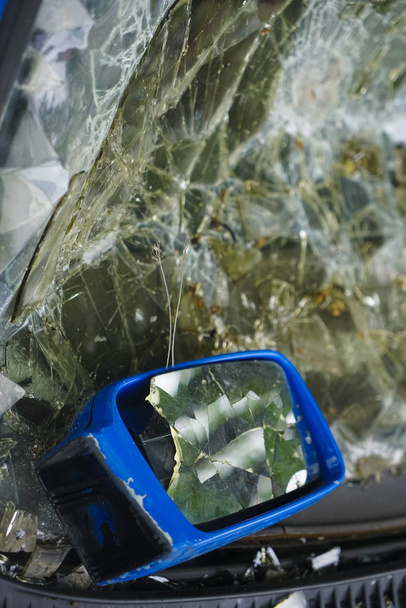 Cracked rear view mirror on a blue car - 写真・画像