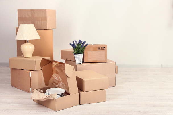 Moving boxes on the floor in empty room - 写真・画像