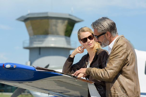 female air traffic control tower worker with manager outdoors - Foto, Imagem